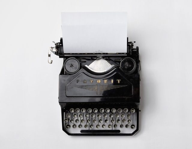 Does content marketing matter in 2022? Old typwriter in white background.